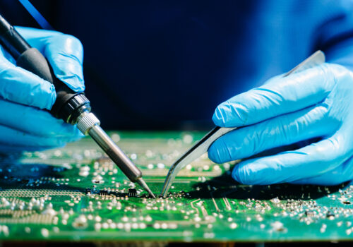 A professional with CircuiTek Solutions working closely to achieve successful PCB assembly near Chicago IL