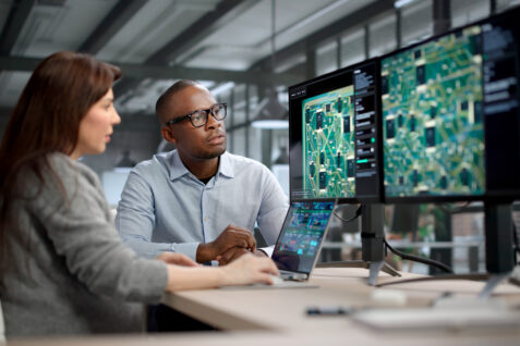 Two engineers work on PCB design that fixes signal loss issues