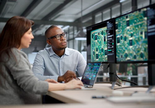 Two engineers work on PCB design that fixes signal loss issues