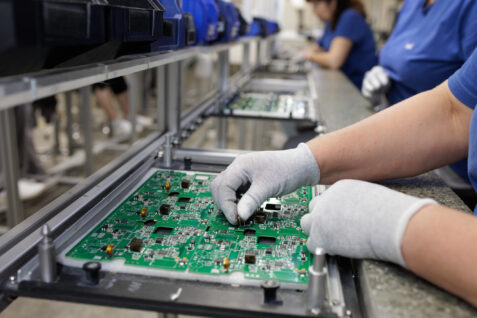 A tech assembles heavy copper PCBs
